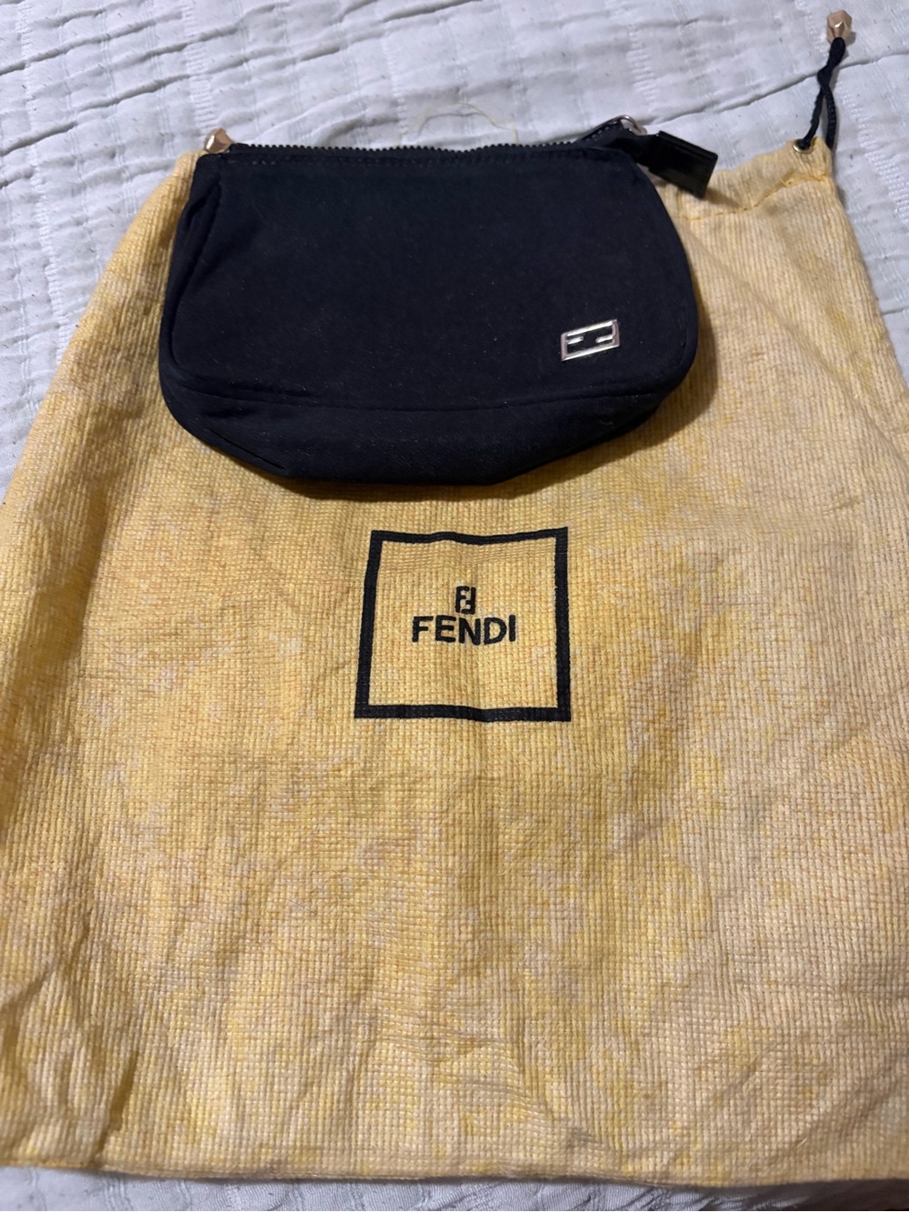 Black Fendi pouch. Great to keep items in and not ruin the inside of your bag.